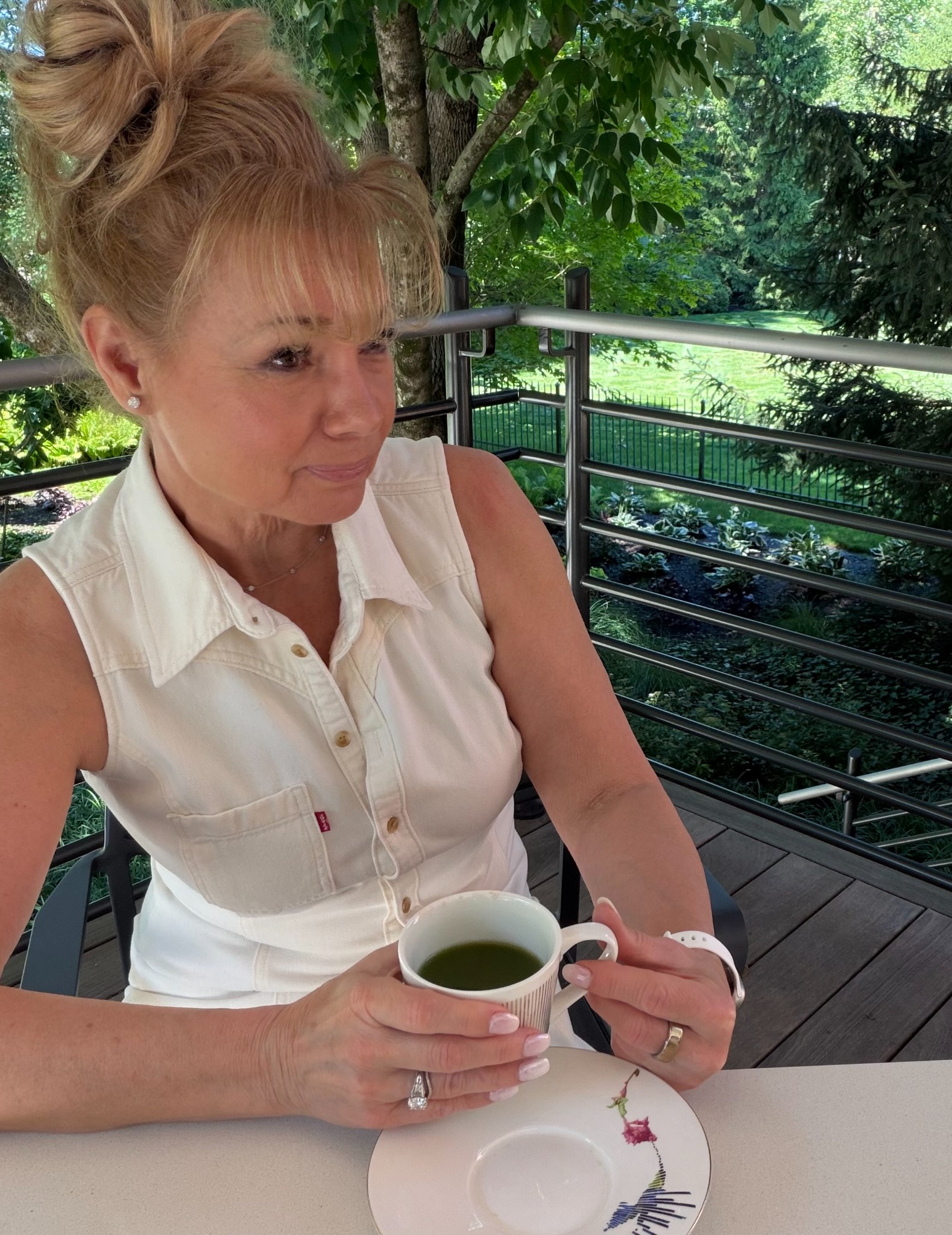 Lana enjoying tea in a peaceful garden